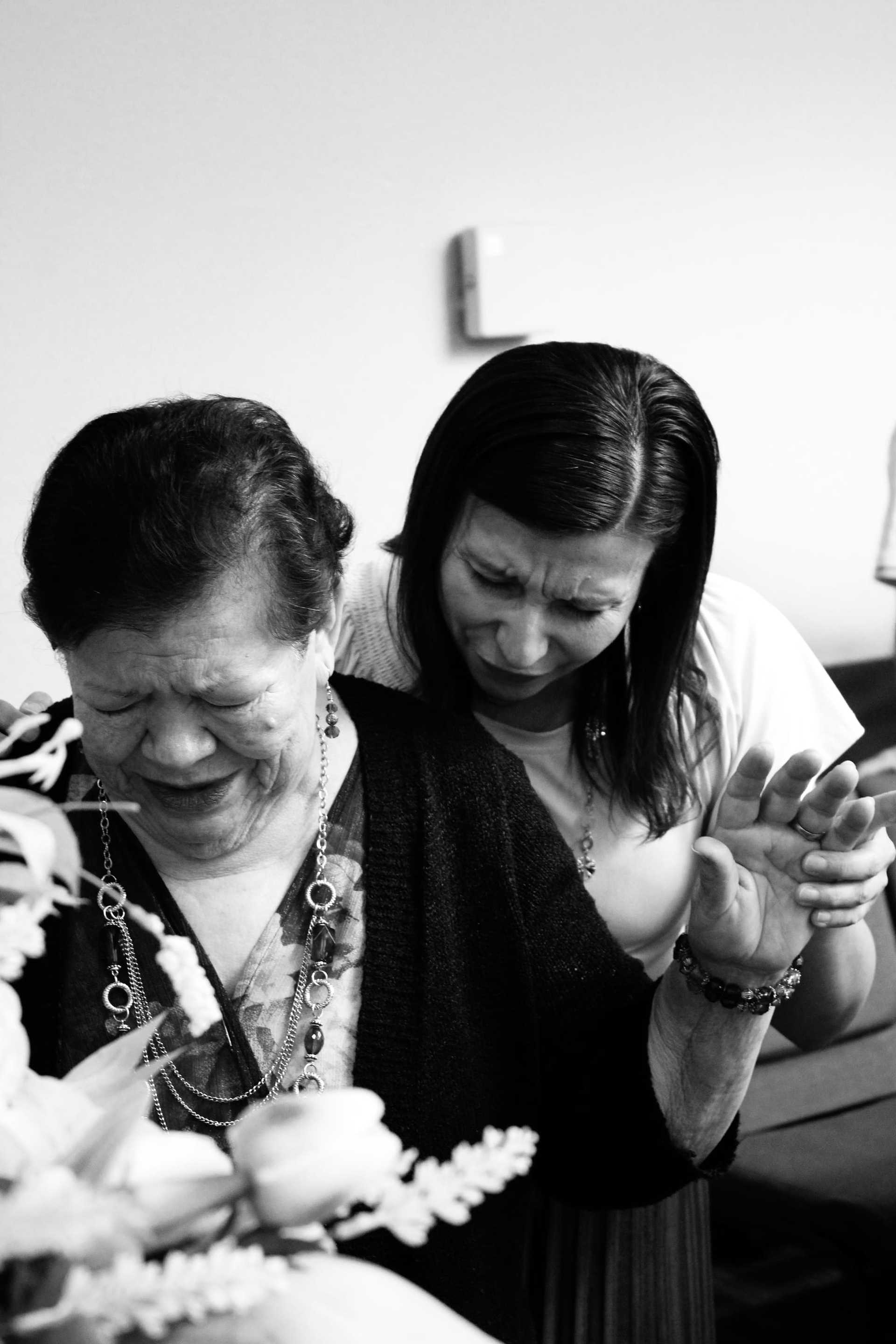 Two women embracing and comforting each other in a heartfelt moment.